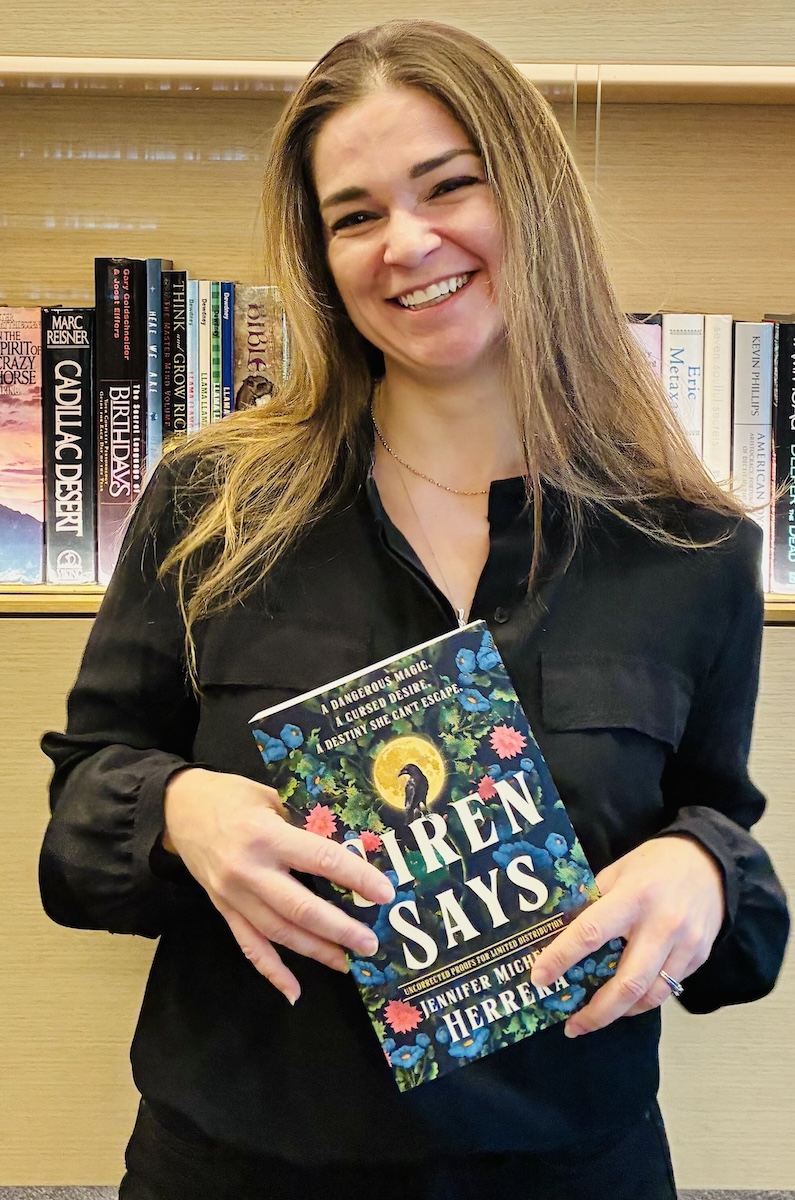 Jennifer holding a copy of 'Siren Says'