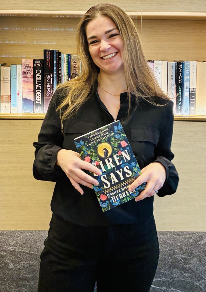 Jennifer holding a copy of 'Siren Says'